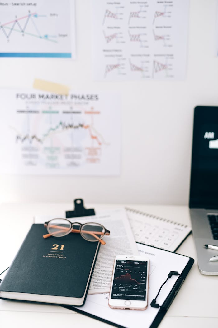 A workspace with smartphone and financial graphs, ideal for business concepts.